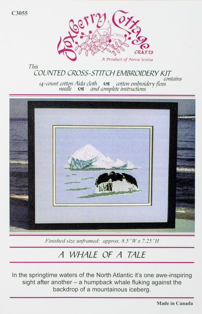 Cross stitch kit of a whale diving in front of an iceberg. 