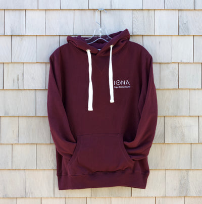  Maroon Coloured Hoody with white drawstrings. Embroidered logo which says 'Iona Cape Breton Island'