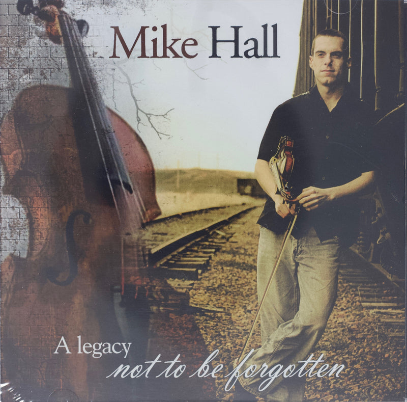 A Legacy Not To Be Forgotten CD Cover. Image of Mike Hall standing on train tracks with fiddle. 